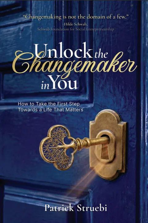 Unlock the Changemaker in You by Patrick Struebi — a brass key in the lock of a deep blue door